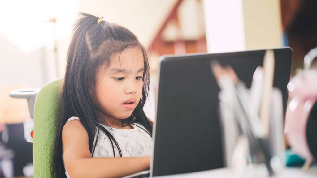 little girl using laptop