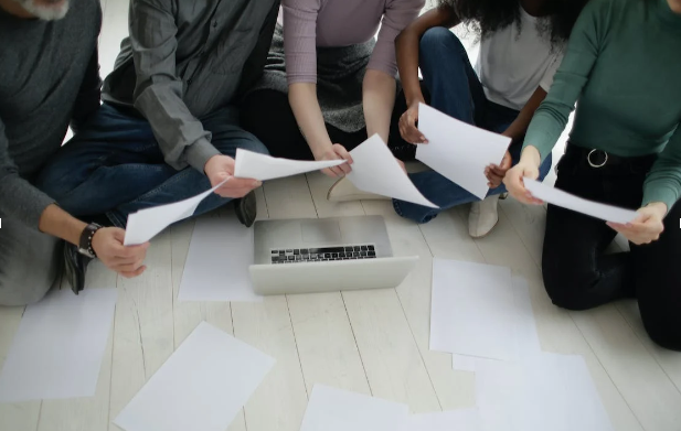 Group of people holding papers