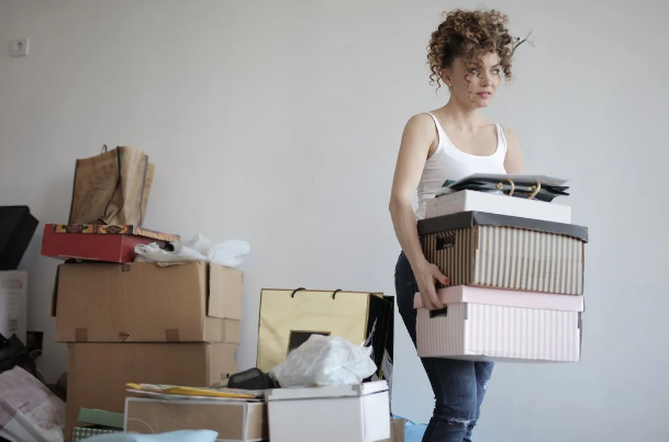 Girl carrying boxes