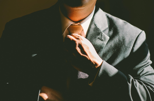 man fixing tie