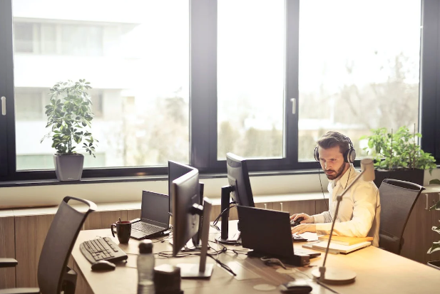 man with headphones working on PC