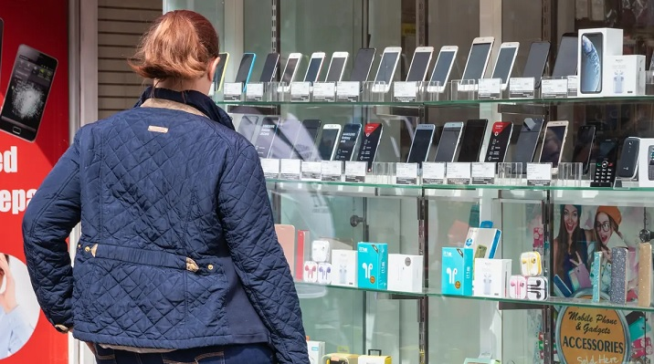 woman looking at mobile phones on display