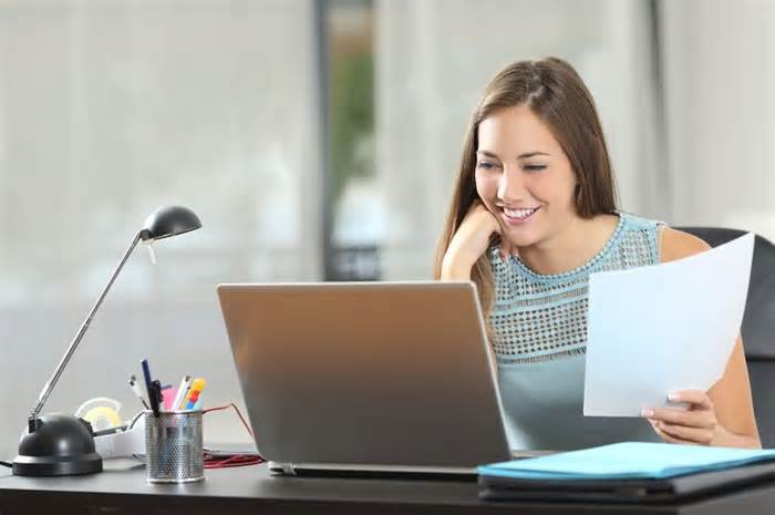 pretty woman looks at laptop screen