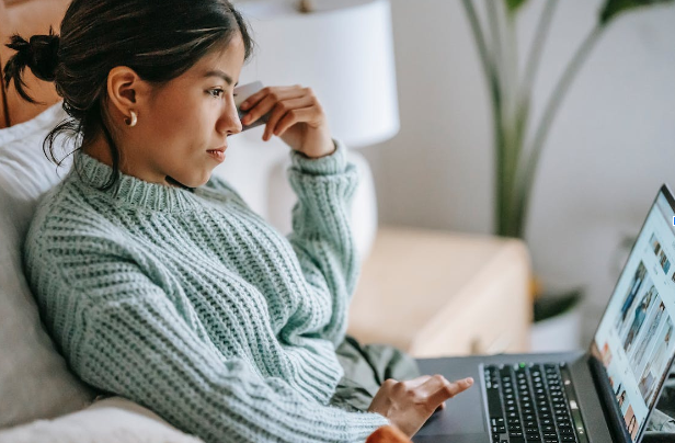 woman watching images on laptop screen