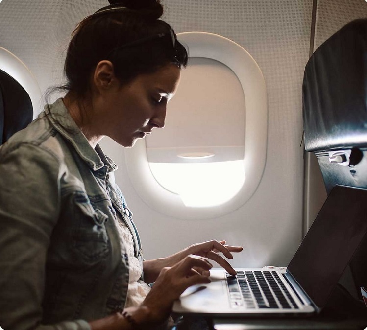 women working on laptop during a flight